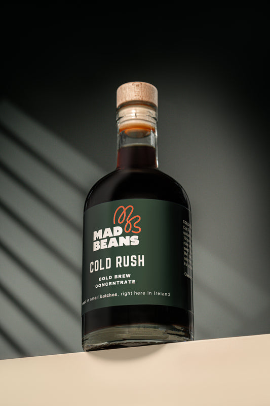 Bottle of Mad Beans Cold Rush cold brew concentrate with a cork lid on a dark background